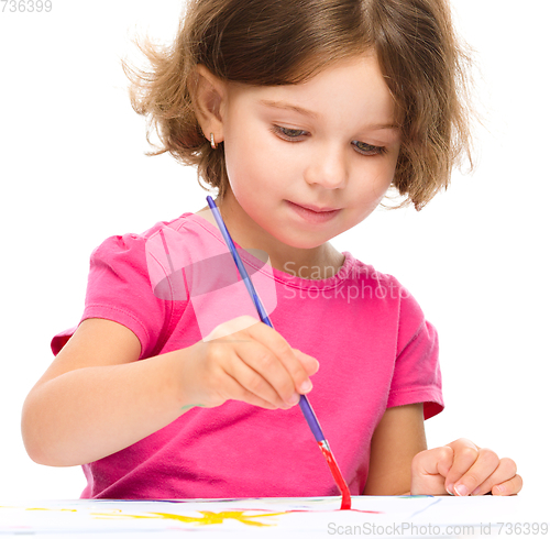 Image of Little girl is painting with gouache