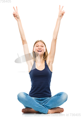Image of Young woman is raised her hands up in joy