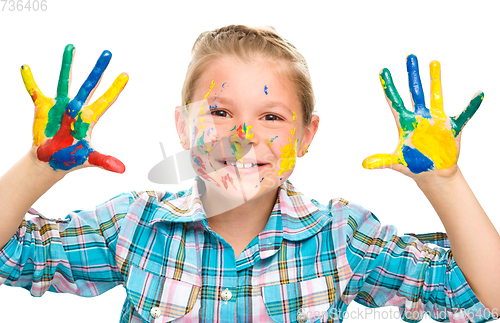 Image of Portrait of a cute girl playing with paints