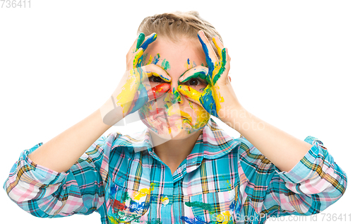 Image of Portrait of a cute girl playing with paints