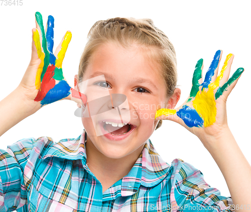 Image of Portrait of a cute girl playing with paints