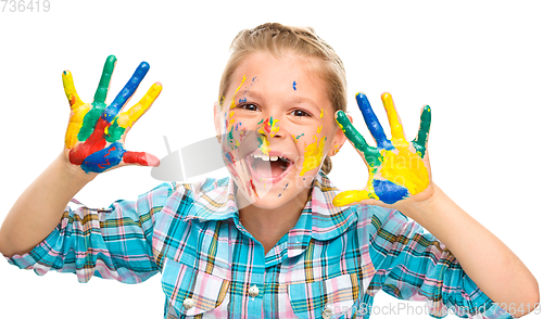 Image of Portrait of a cute girl playing with paints