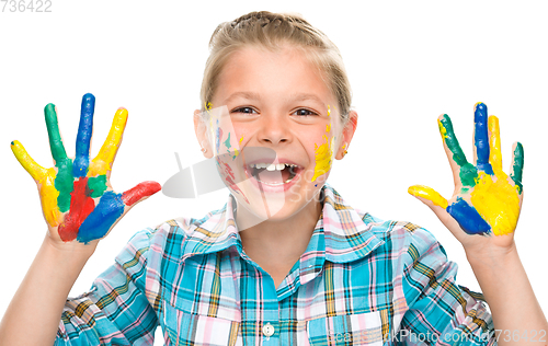 Image of Portrait of a cute girl playing with paints