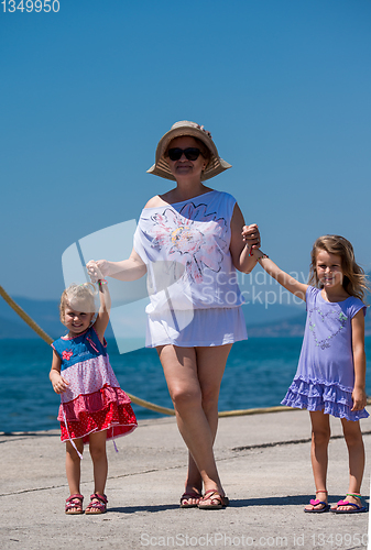 Image of Portrait of a grandmother with her cute little granddaughters by