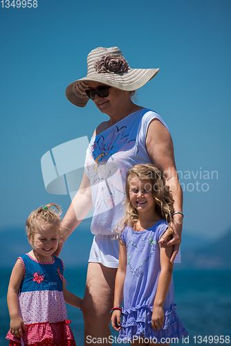 Image of Portrait of a grandmother with her cute little granddaughters by