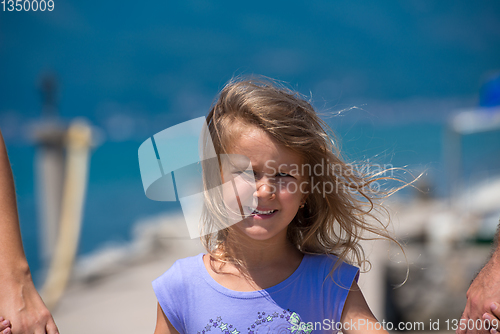 Image of young happy family walking by the sea