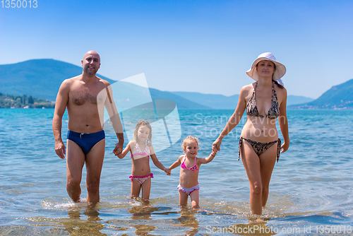 Image of portrait of happy family with kids during summer vacation