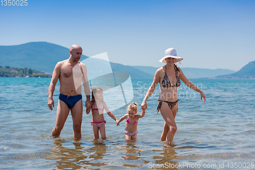 Image of portrait of happy family with kids during summer vacation