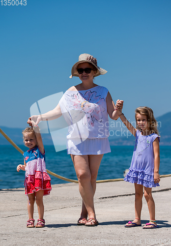 Image of Portrait of a grandmother with her cute little granddaughters by