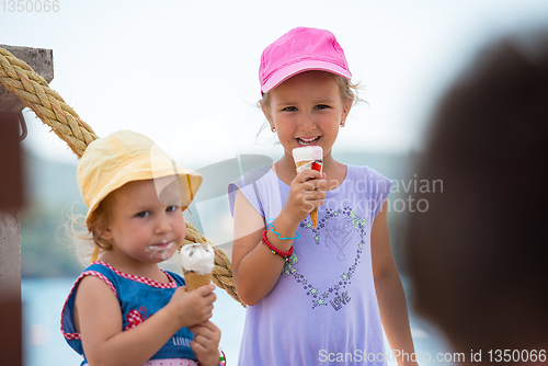 Image of little girls eating ice cream by the sea