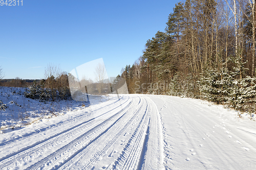 Image of rural road covered with snow closeup