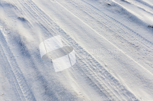 Image of traces of the wheels of the car on the snow-covered road