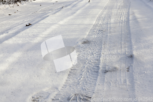 Image of traces of the wheels of the car on the snow-covered road