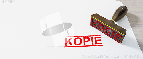 Image of red stamp with the word copy in german language on white paper b