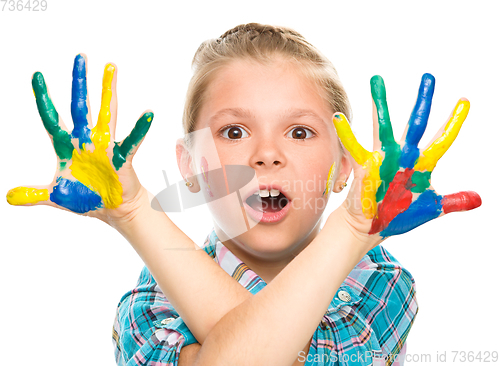 Image of Portrait of a cute girl playing with paints