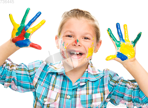 Image of Portrait of a cute girl playing with paints