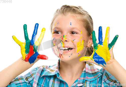 Image of Portrait of a cute girl playing with paints