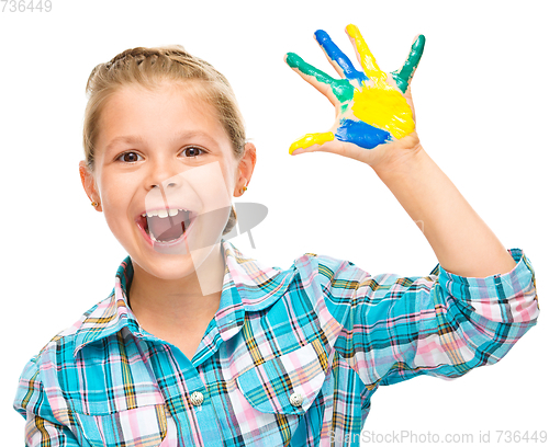 Image of Portrait of a cute girl playing with paints