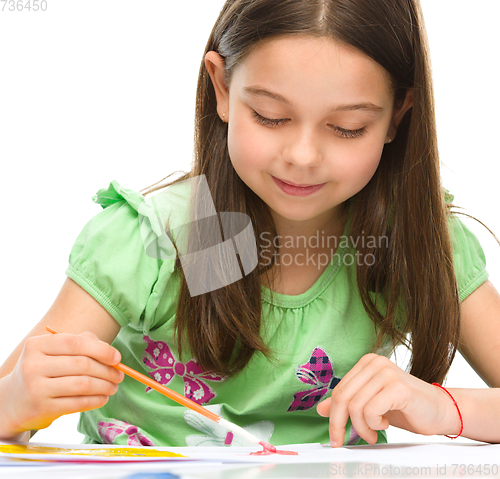 Image of Little girl is painting with gouache