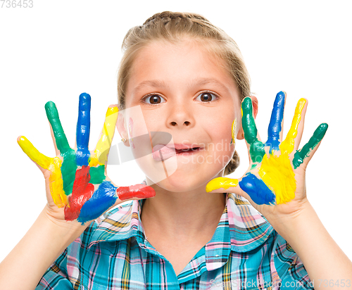 Image of Portrait of a cute girl playing with paints