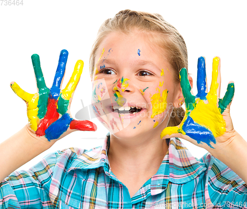 Image of Portrait of a cute girl playing with paints