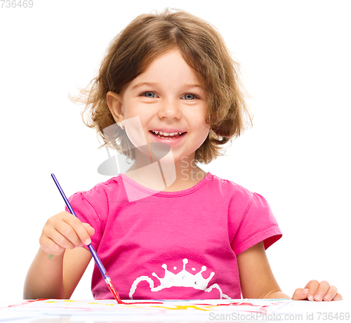 Image of Little girl is painting with gouache