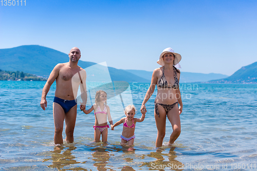 Image of portrait of happy family with kids during summer vacation