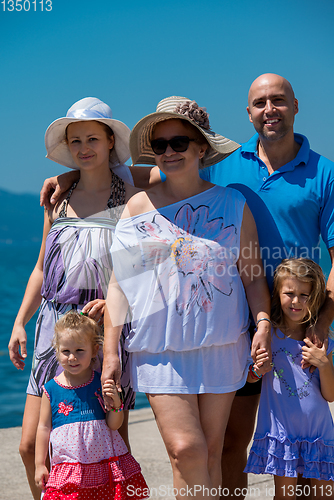 Image of Portrait of happy multi generation family by the sea