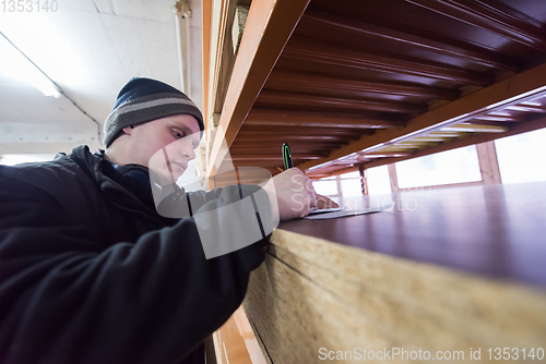 Image of carpenter writing a receipt
