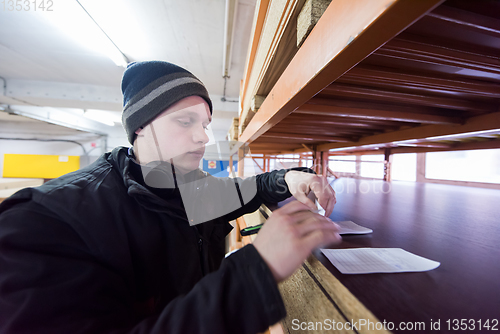 Image of carpenter writing a receipt