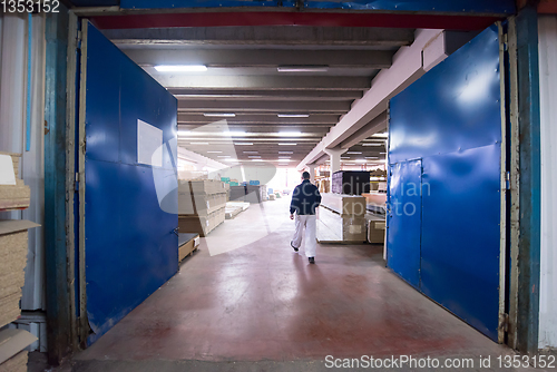 Image of carpenter walking through factory