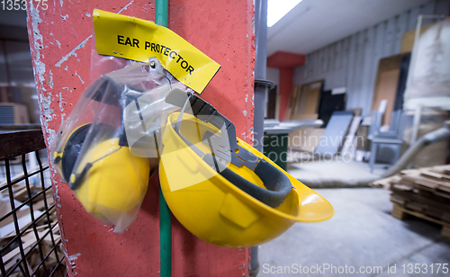 Image of standard security equipment yellow helmet and ears protection