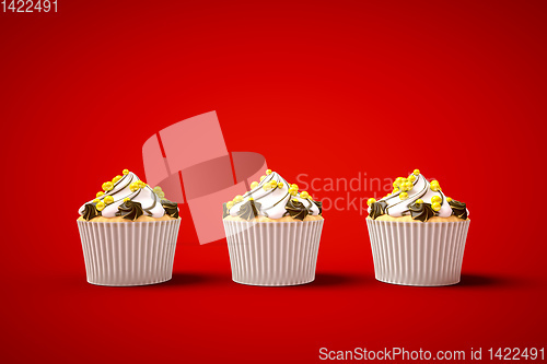 Image of three cupcakes on red background