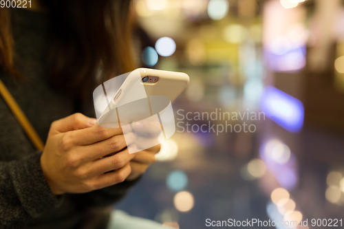 Image of Woman holding mobile phone