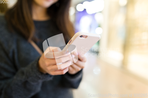 Image of Woman sending sms on cellphone