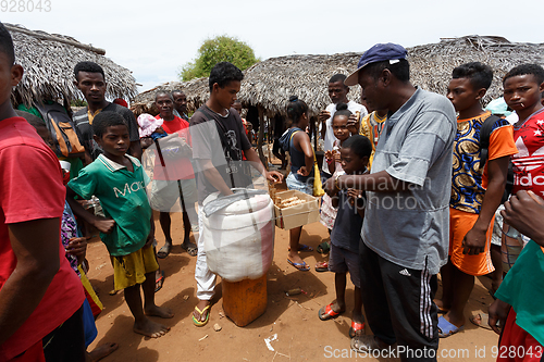 Image of Man sell ice cream on rural Madagascar marketplace