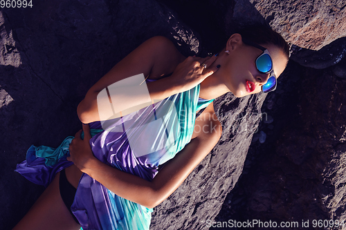 Image of beautiful girl on rocky shore