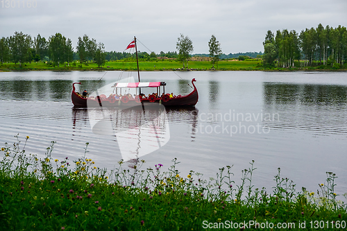 Image of Old wooden viking boat in river