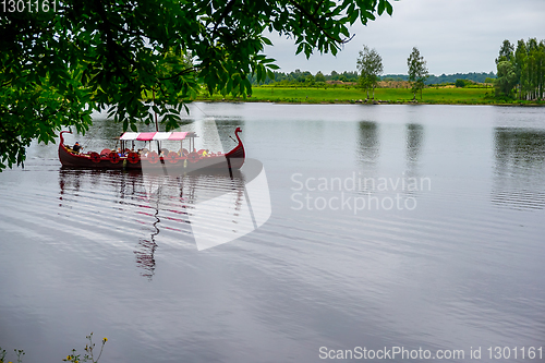 Image of Old wooden viking boat in river