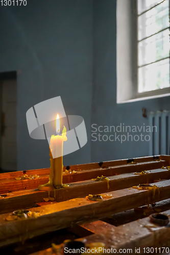 Image of Burning candle at Koknese Evangelical Lutheran Church.