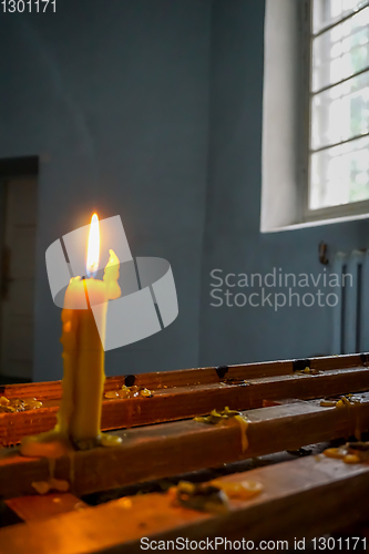 Image of Burning candle at Koknese Evangelical Lutheran Church.