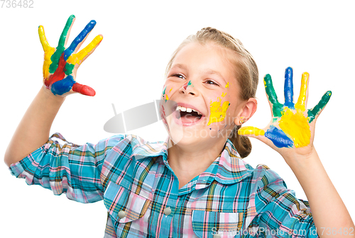 Image of Portrait of a cute girl playing with paints