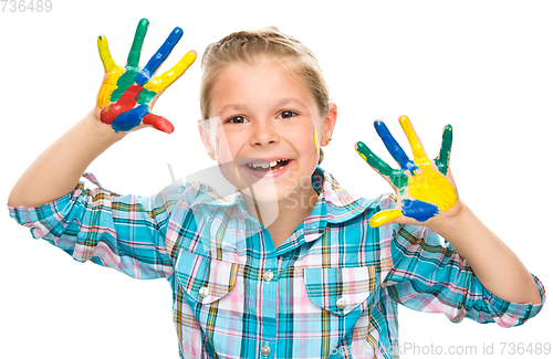 Image of Portrait of a cute girl playing with paints