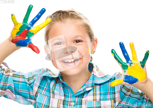 Image of Portrait of a cute girl playing with paints