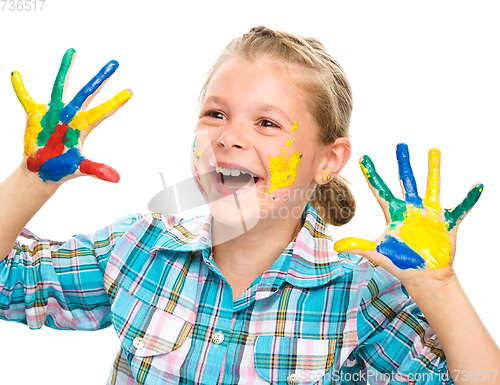 Image of Portrait of a cute girl playing with paints