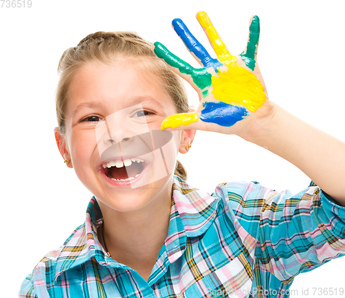 Image of Portrait of a cute girl playing with paints
