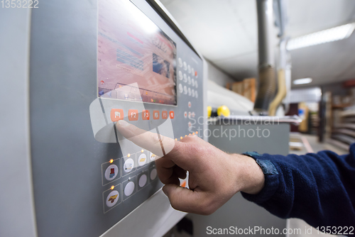 Image of carpenter calculating and programming a cnc wood working machine