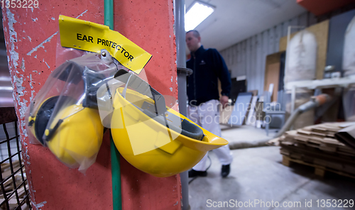 Image of standard security equipment yellow helmet and ears protection