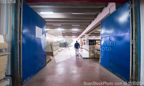 Image of carpenter walking through factory