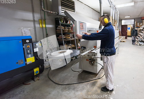 Image of carpenter calculating and programming a cnc wood working machine